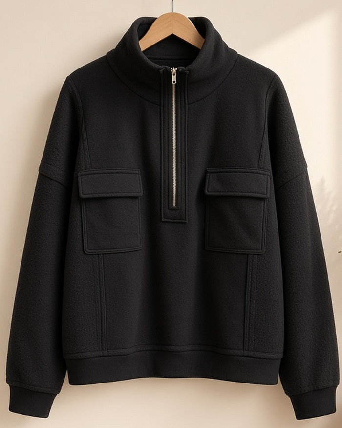 Black half-zip pullover on hanger