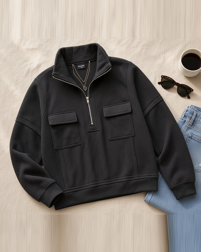 Black half-zip pullover flat lay
